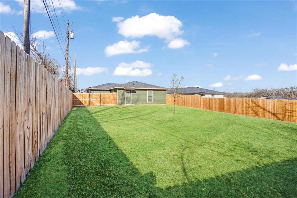 2408 Miller Street Denison, TX 75020 - Photo 24 of 26 a view of an house with backyard and deck
