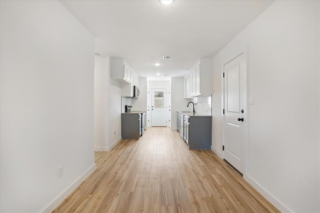 2408 Miller Street Denison, TX 75020 - Photo 8 of 26 a view of a kitchen with wooden floor