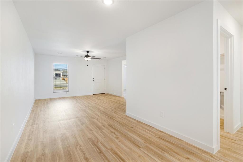 2408 Miller Street Denison, TX 75020 - Photo 9 of 26 wooden floor in an empty room with a window