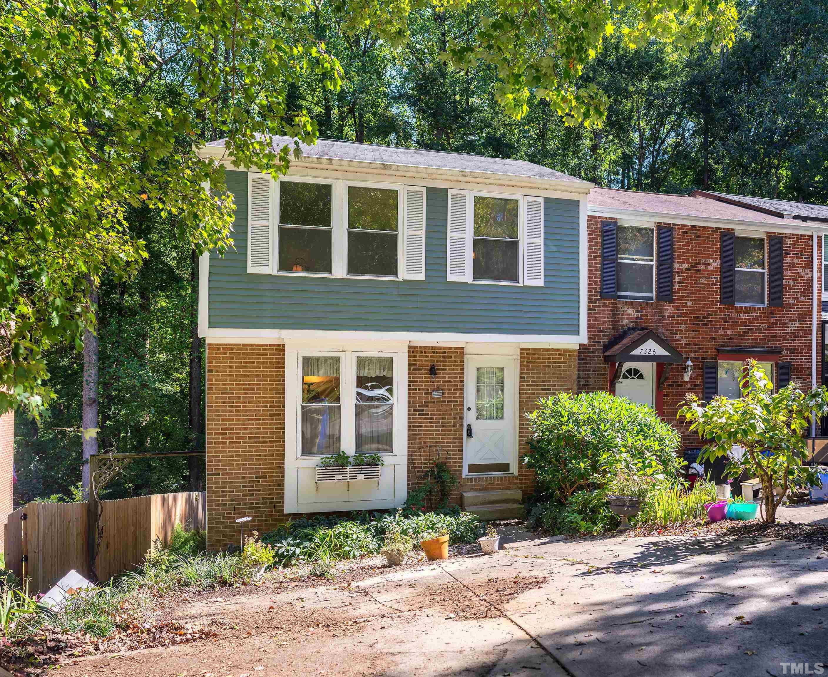 7328 Summerland Drive Raleigh, NC 27612 - Photo 1 of 22 a front view of a house with a yard