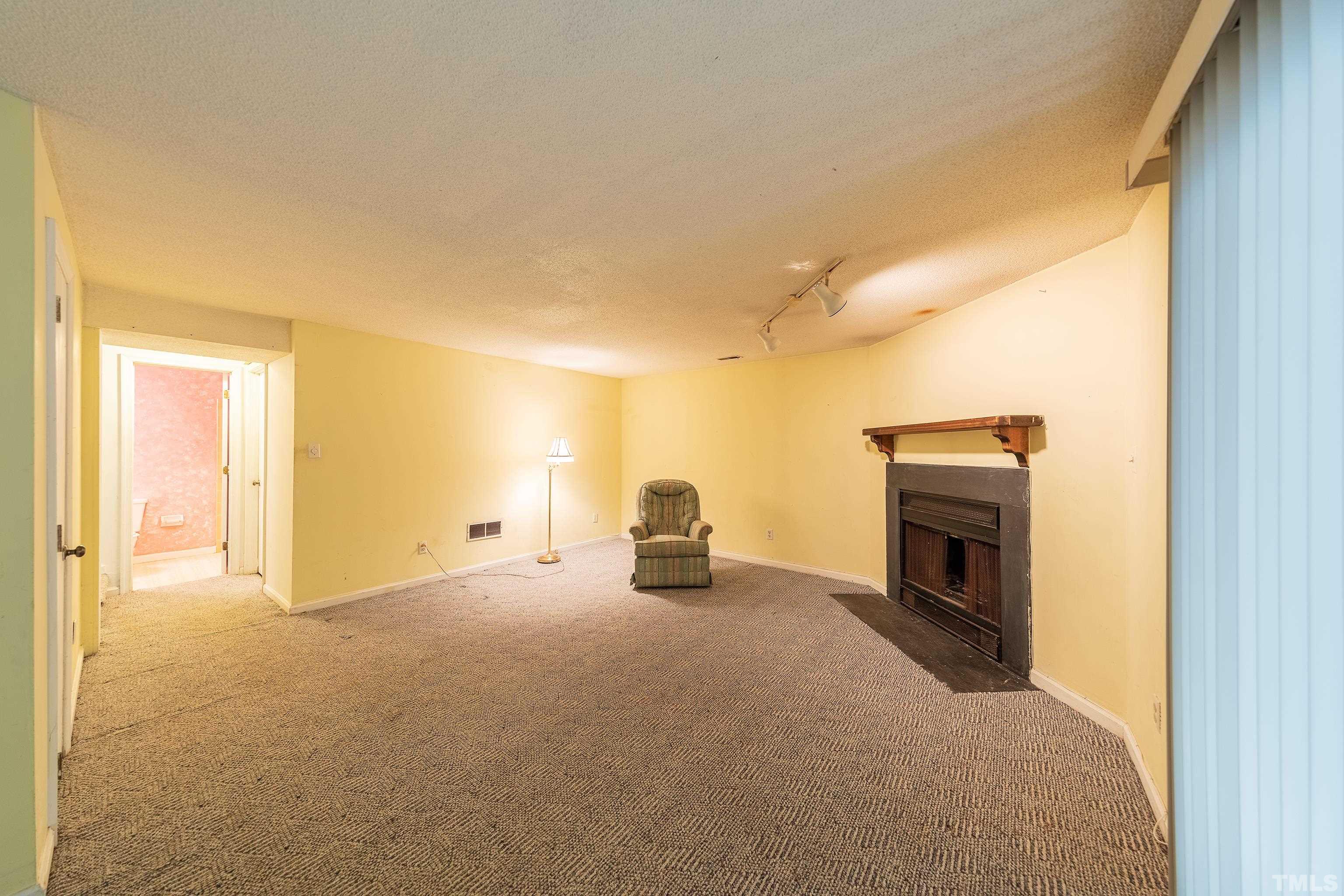 7328 Summerland Drive Raleigh, NC 27612 - Photo 12 of 22 a view of empty room with fireplace