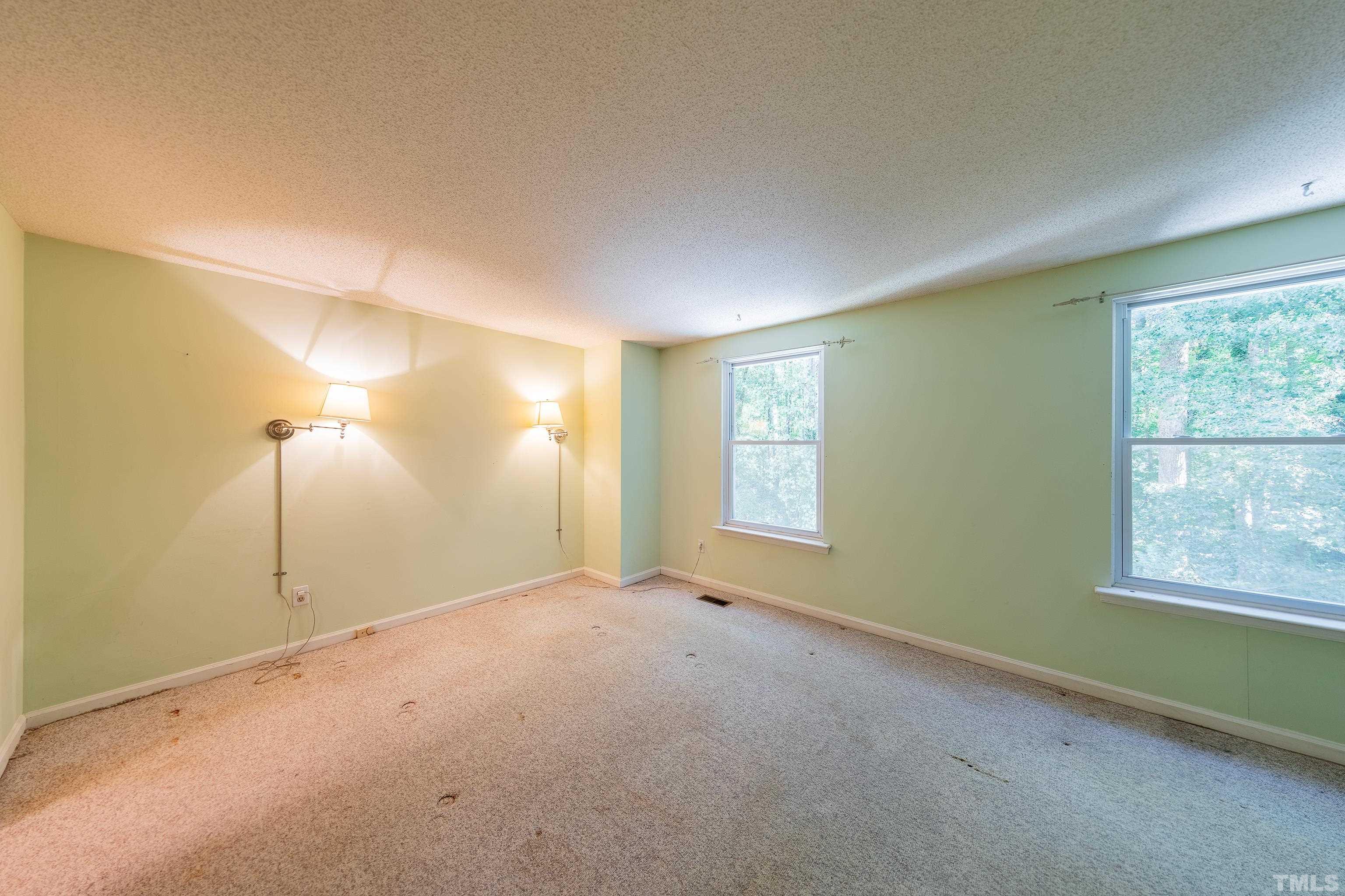 7328 Summerland Drive Raleigh, NC 27612 - Photo 13 of 22 a view of an empty room with a window