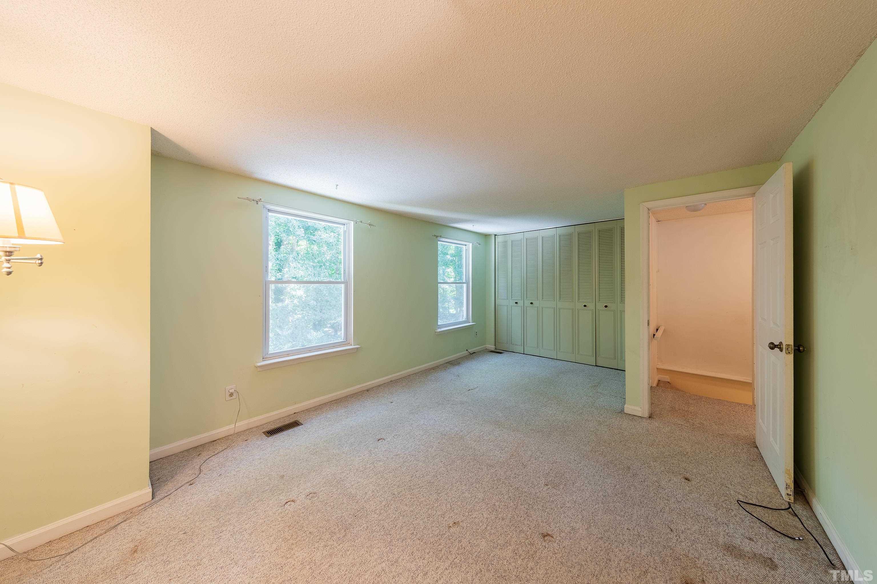 7328 Summerland Drive Raleigh, NC 27612 - Photo 14 of 22 a view of an empty room with a window