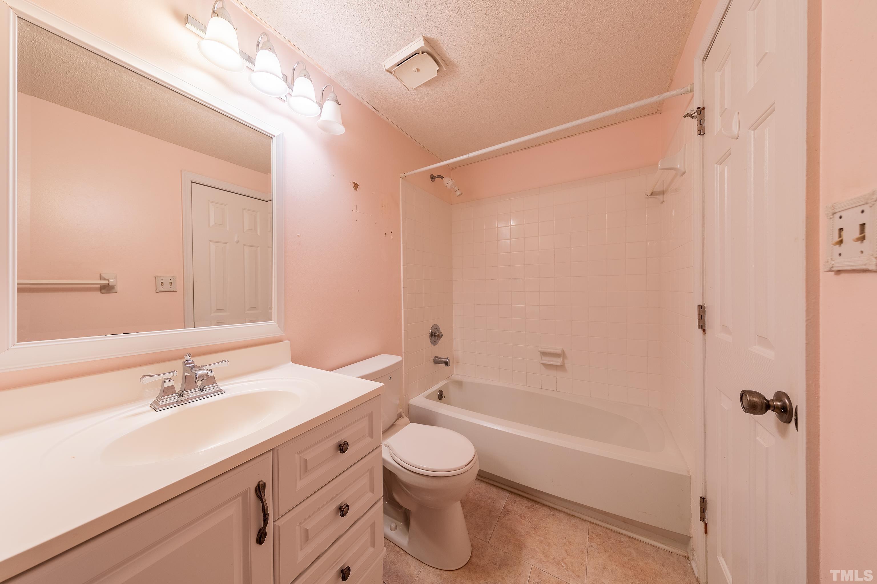 7328 Summerland Drive Raleigh, NC 27612 - Photo 17 of 22 a bathroom with a double vanity sink toilet tub and shower
