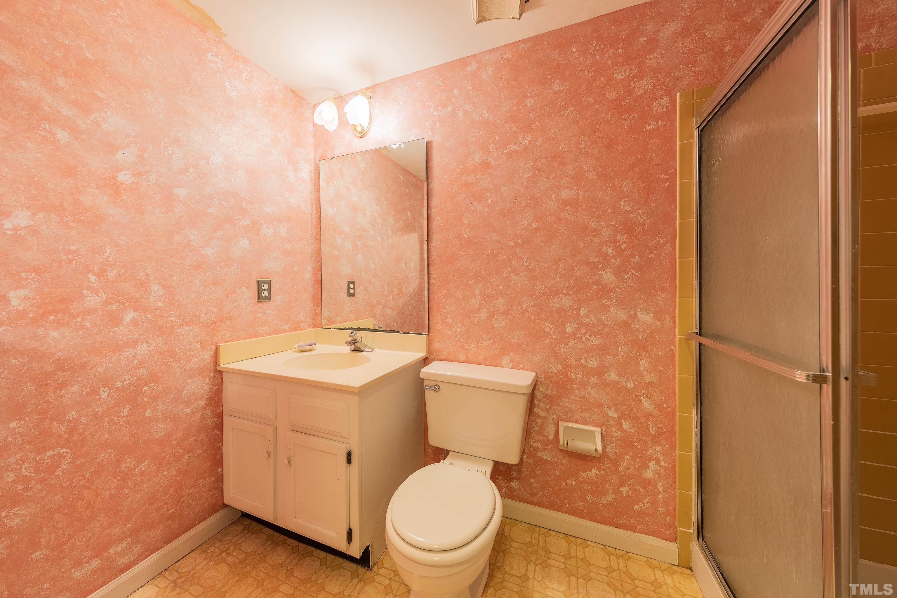 7328 Summerland Drive Raleigh, NC 27612 - Photo 18 of 22 a white toilet sitting next to a bathroom sink