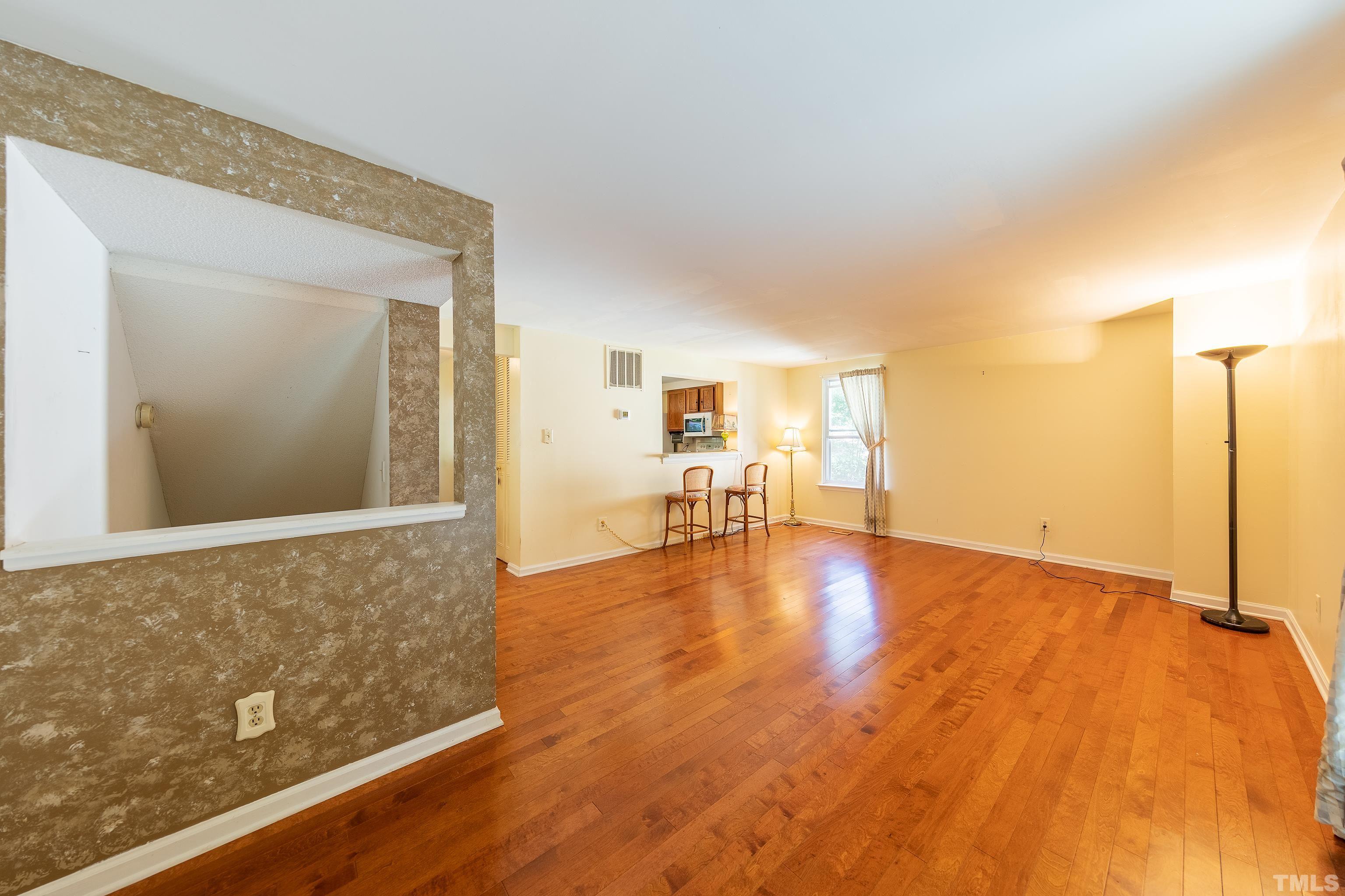 7328 Summerland Drive Raleigh, NC 27612 - Photo 8 of 22 a view of empty room with wooden floor