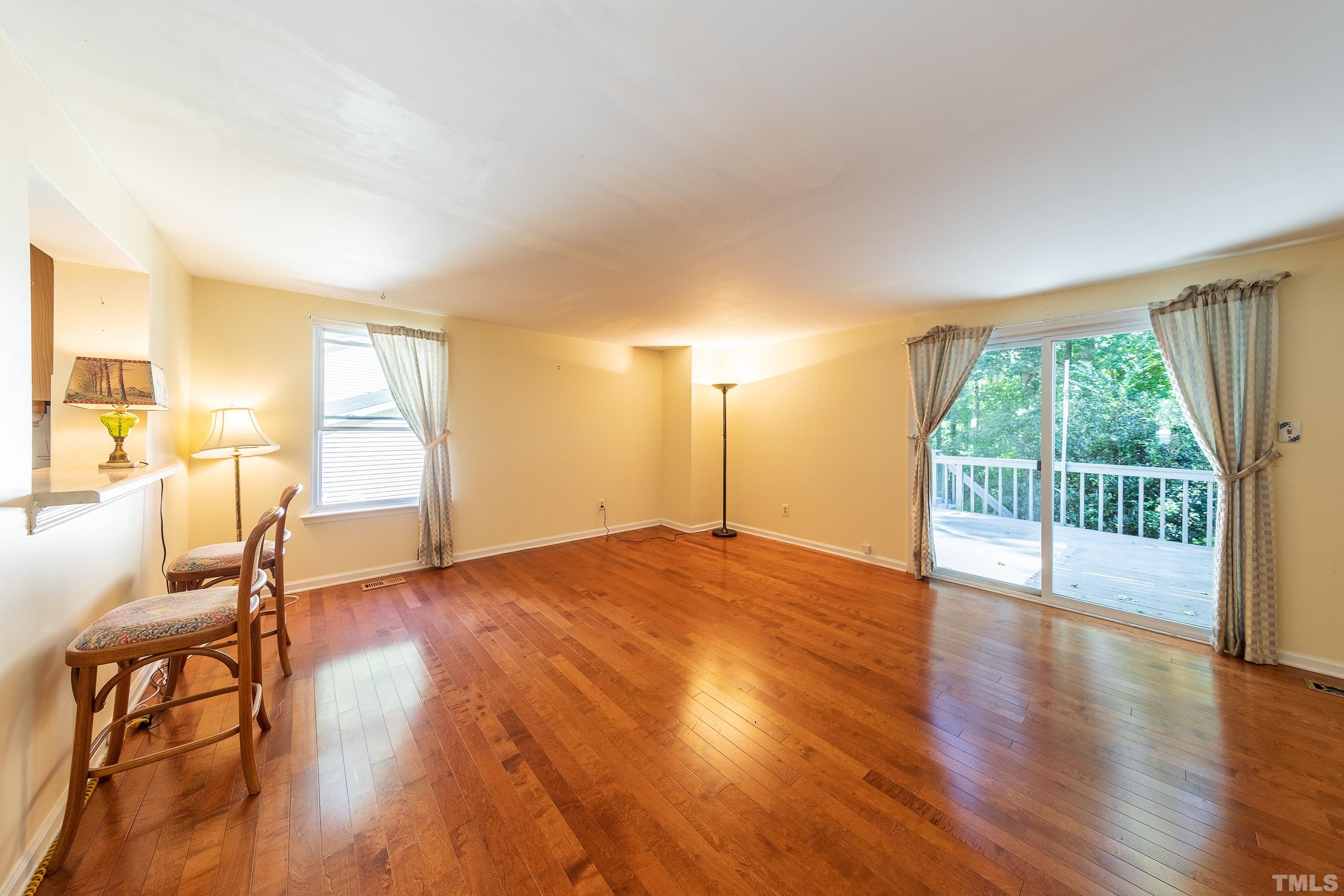 7328 Summerland Drive Raleigh, NC 27612 - Photo 9 of 22 a view of an empty room and wooden floor
