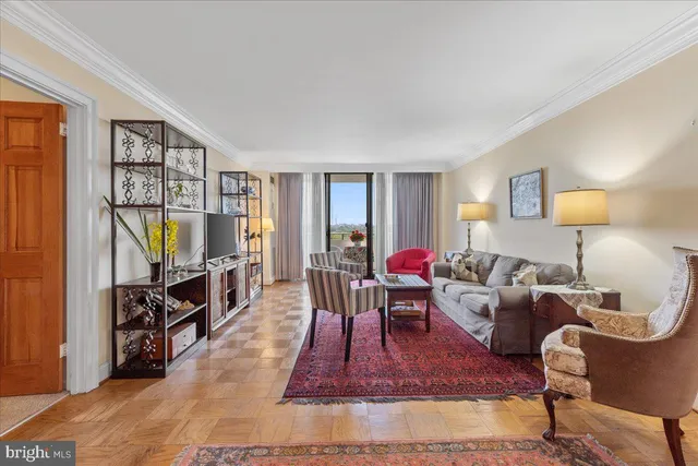 a living room with furniture a rug and a flat screen tv