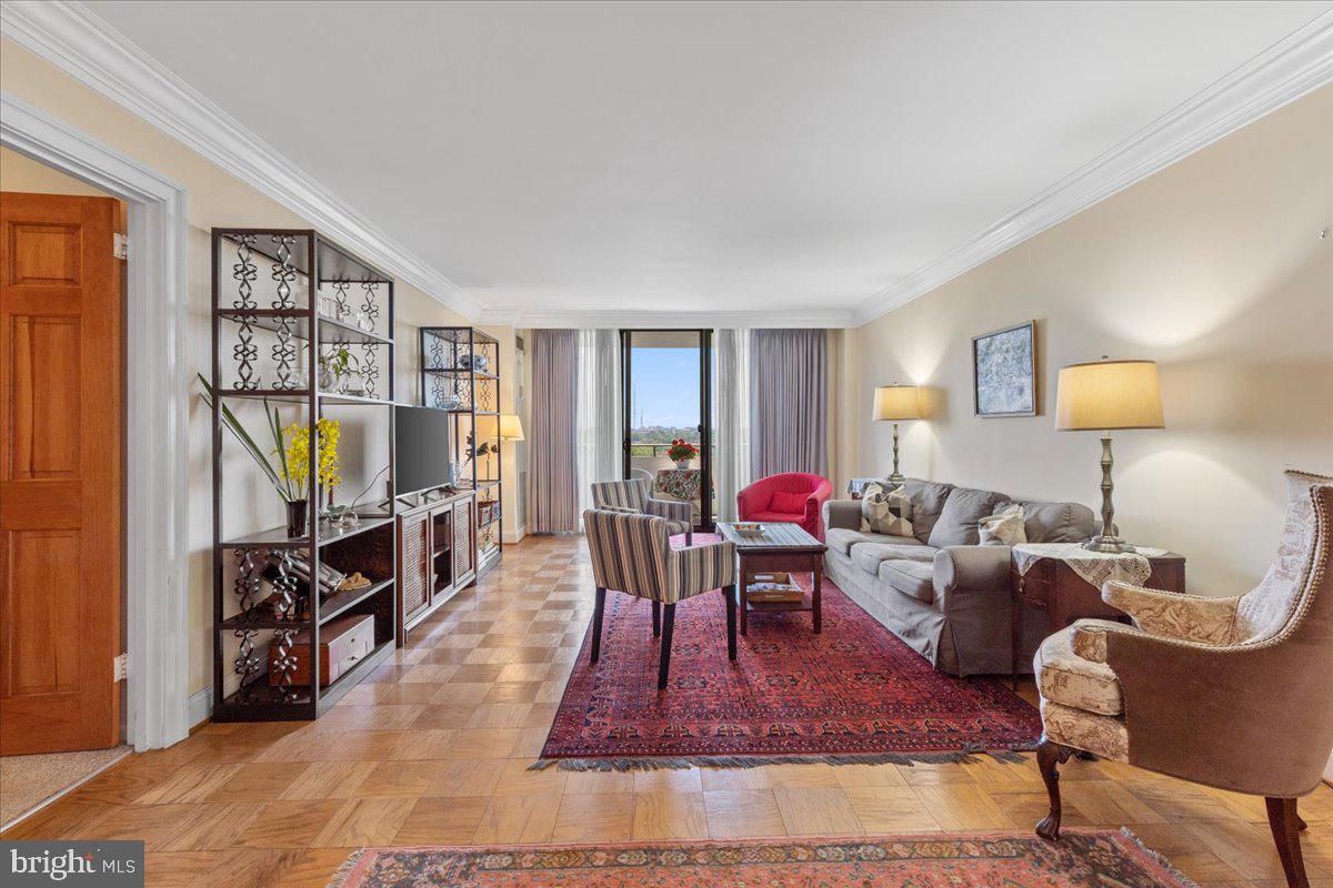 5101 River Road, Unit 1506 Bethesda, MD 20816 - Photo 1 of 37 a living room with furniture a rug and a flat screen tv