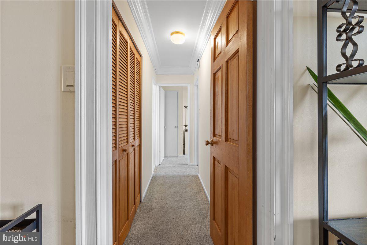 5101 River Road, Unit 1506 Bethesda, MD 20816 - Photo 13 of 37 a view of a hallway with wooden floor and staircase