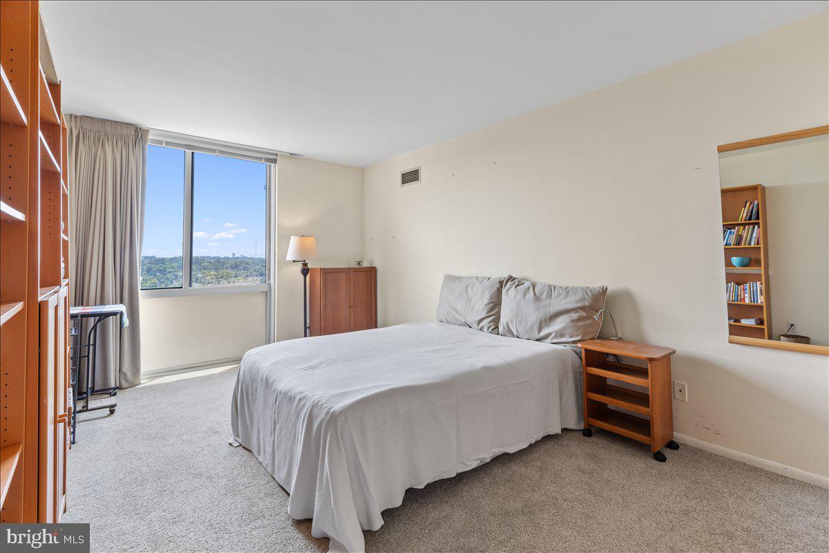 5101 River Road, Unit 1506 Bethesda, MD 20816 - Photo 14 of 37 a bedroom with a bed and a window