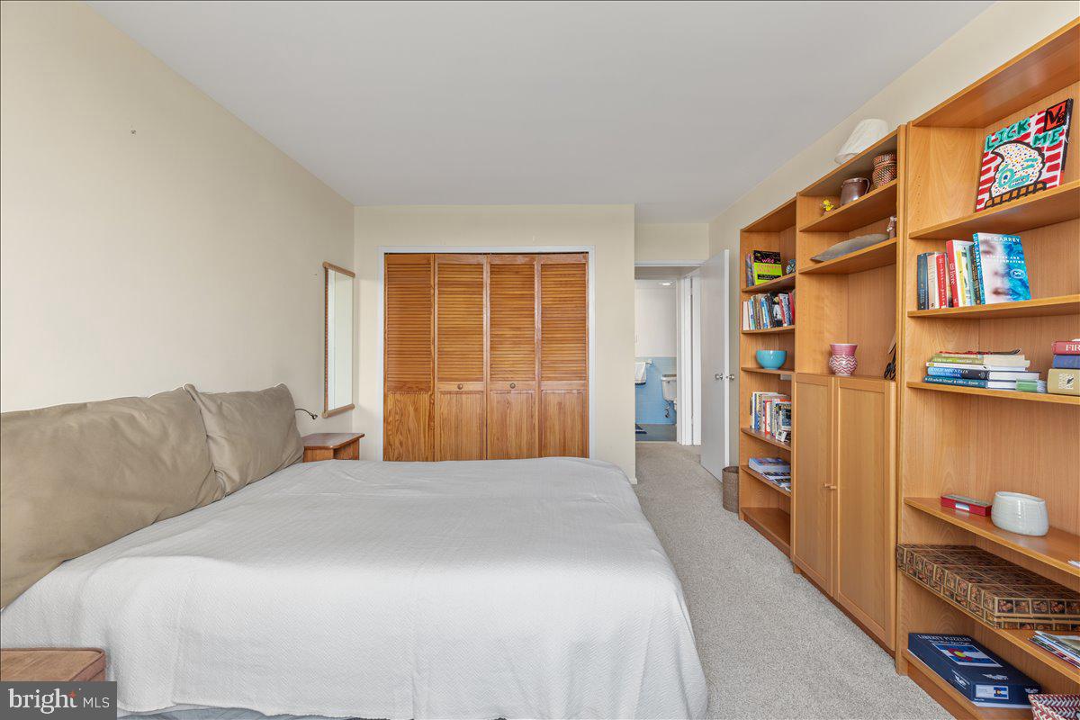5101 River Road, Unit 1506 Bethesda, MD 20816 - Photo 15 of 37 a bedroom with a bed and a book shelf