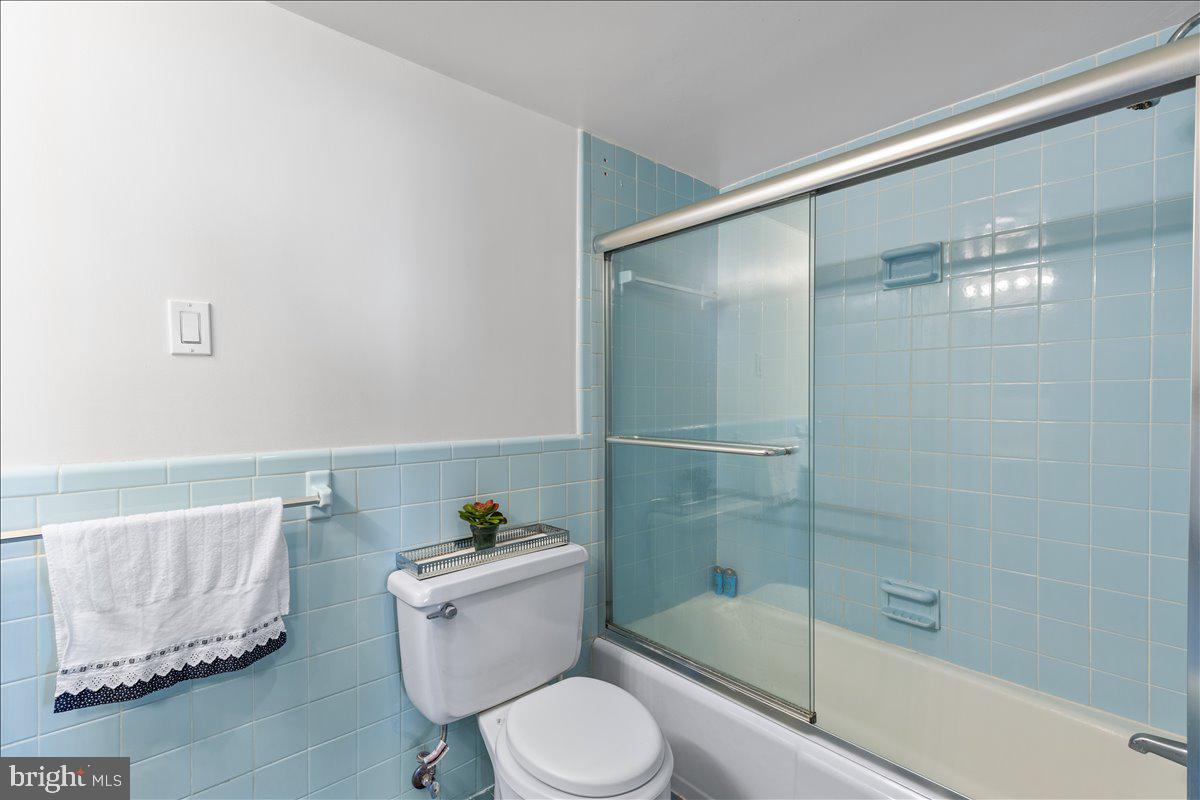 5101 River Road, Unit 1506 Bethesda, MD 20816 - Photo 16 of 37 a bathroom with a shower and a toilet