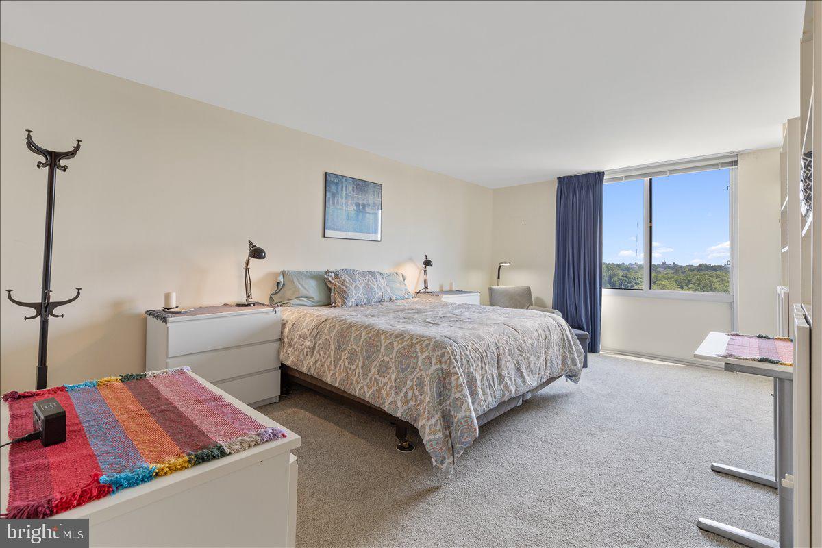 5101 River Road, Unit 1506 Bethesda, MD 20816 - Photo 18 of 37 a bedroom with a bed and a couch