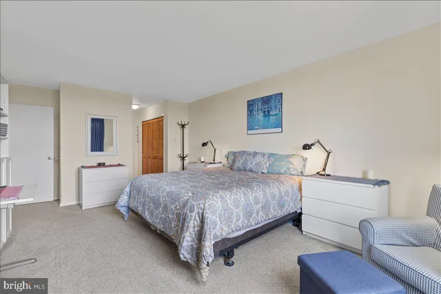 a spacious bedroom with a bed and a couch