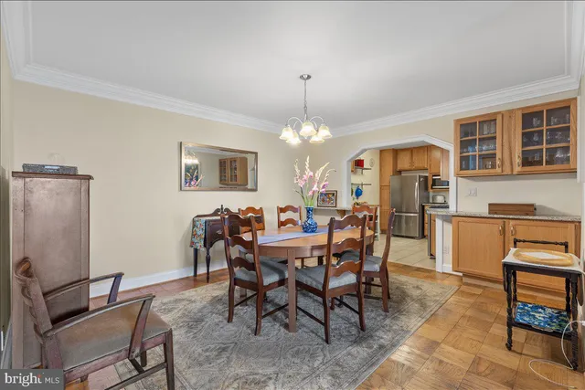 a view of a dining room with furniture and a chandelier