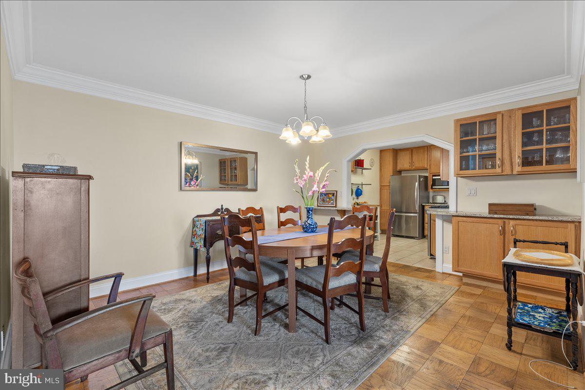 5101 River Road, Unit 1506 Bethesda, MD 20816 - Photo 5 of 37 a view of a dining room with furniture and a chandelier