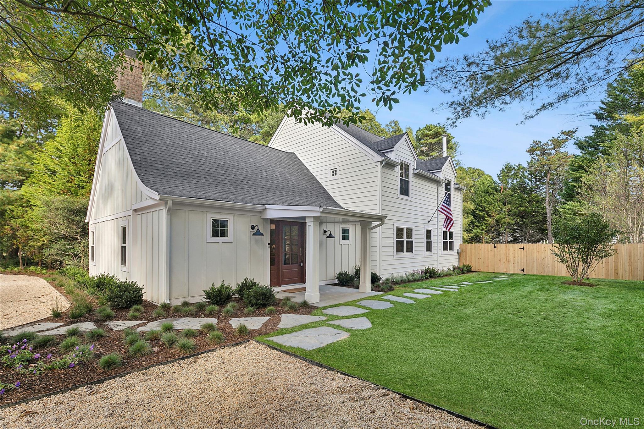 View of front of home featuring board and batten siding, a shingled roof, and a chimney