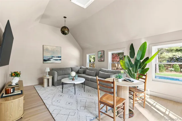 a living room with furniture a window and a flat screen tv