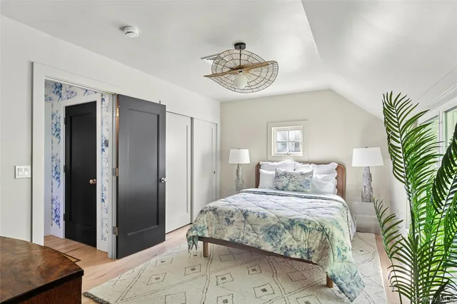 a bedroom with a bed and a chandelier