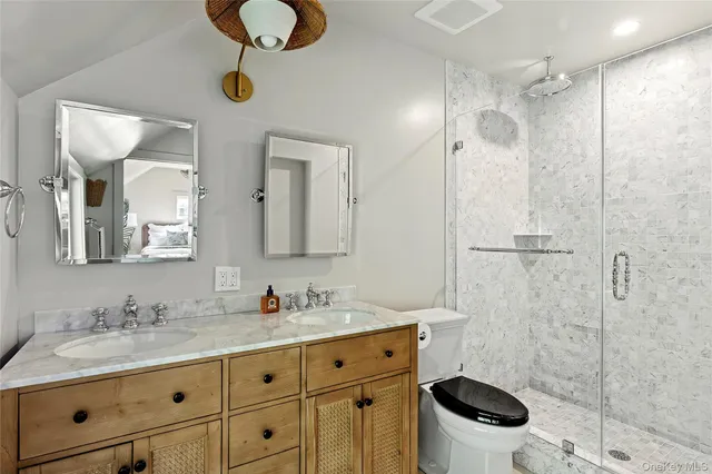 a bathroom with a granite countertop sink mirror and shower