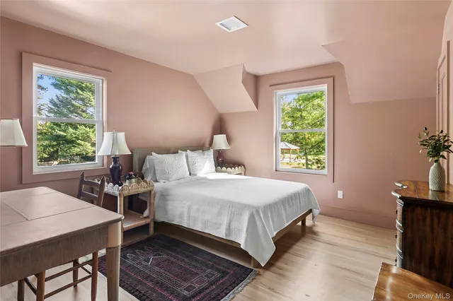 a bedroom with a bed a table and a window