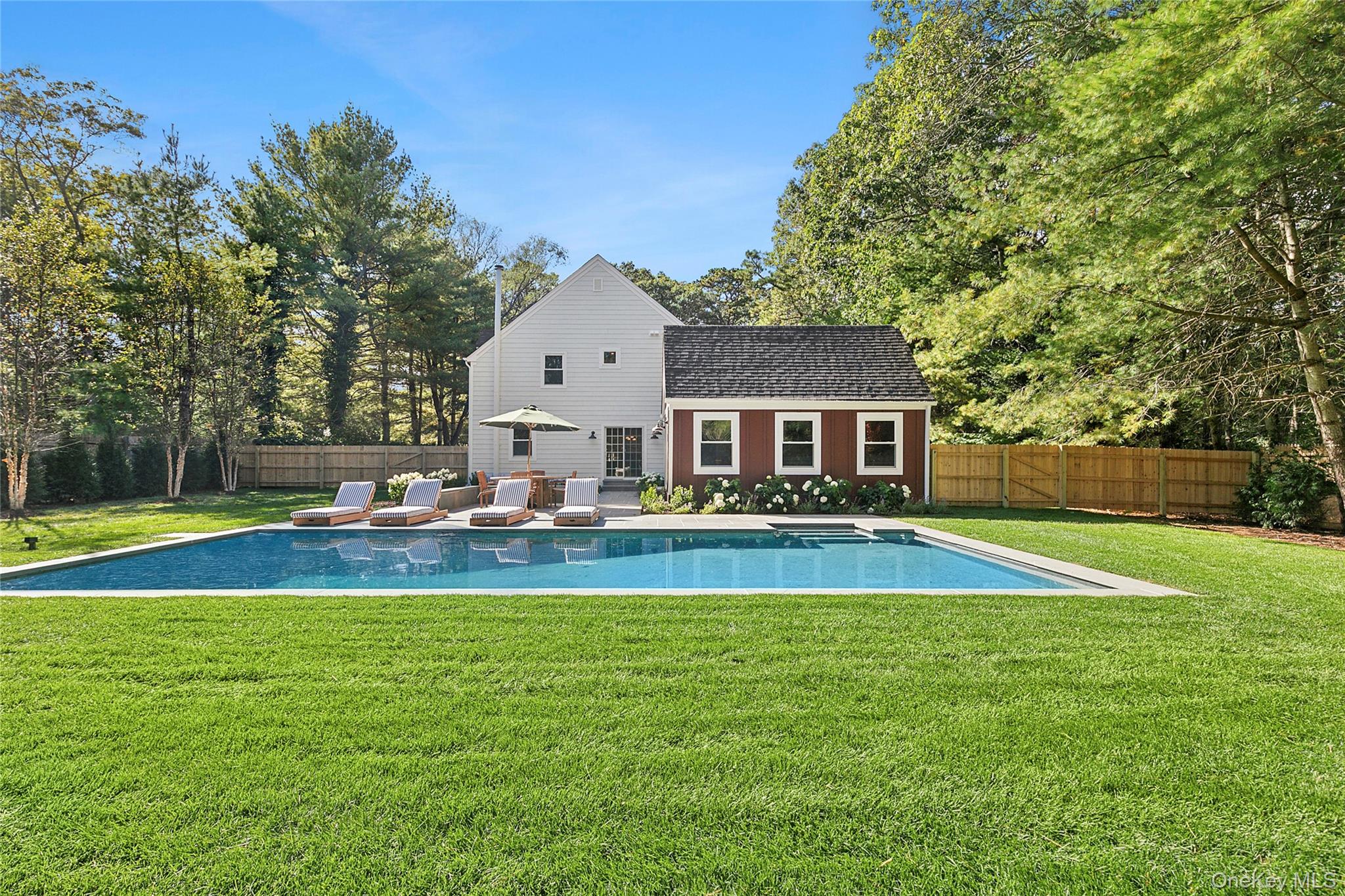 6 East Gate Road Wainscott, NY 11975 - Photo 22 of 24 a view of a house with a big yard and a large tree