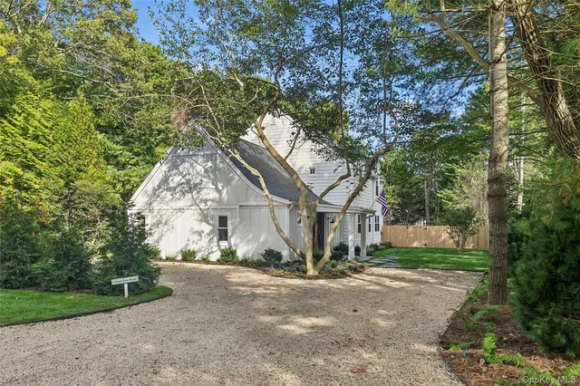 a view of a house with a tree in front