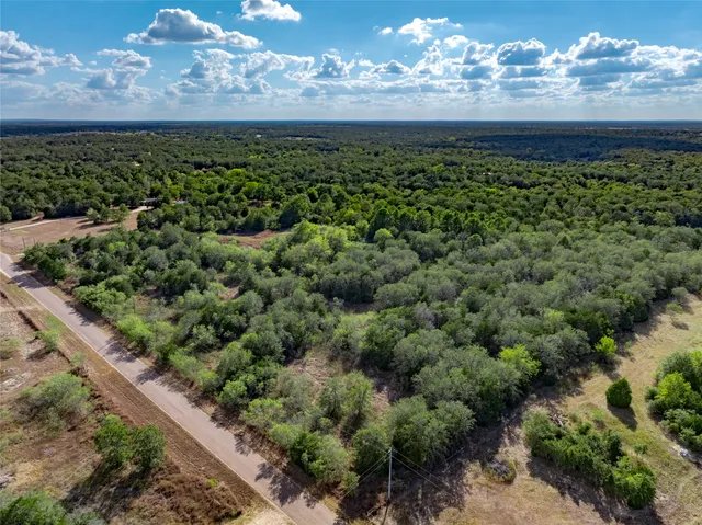 a view of a fountain in middle of the garden