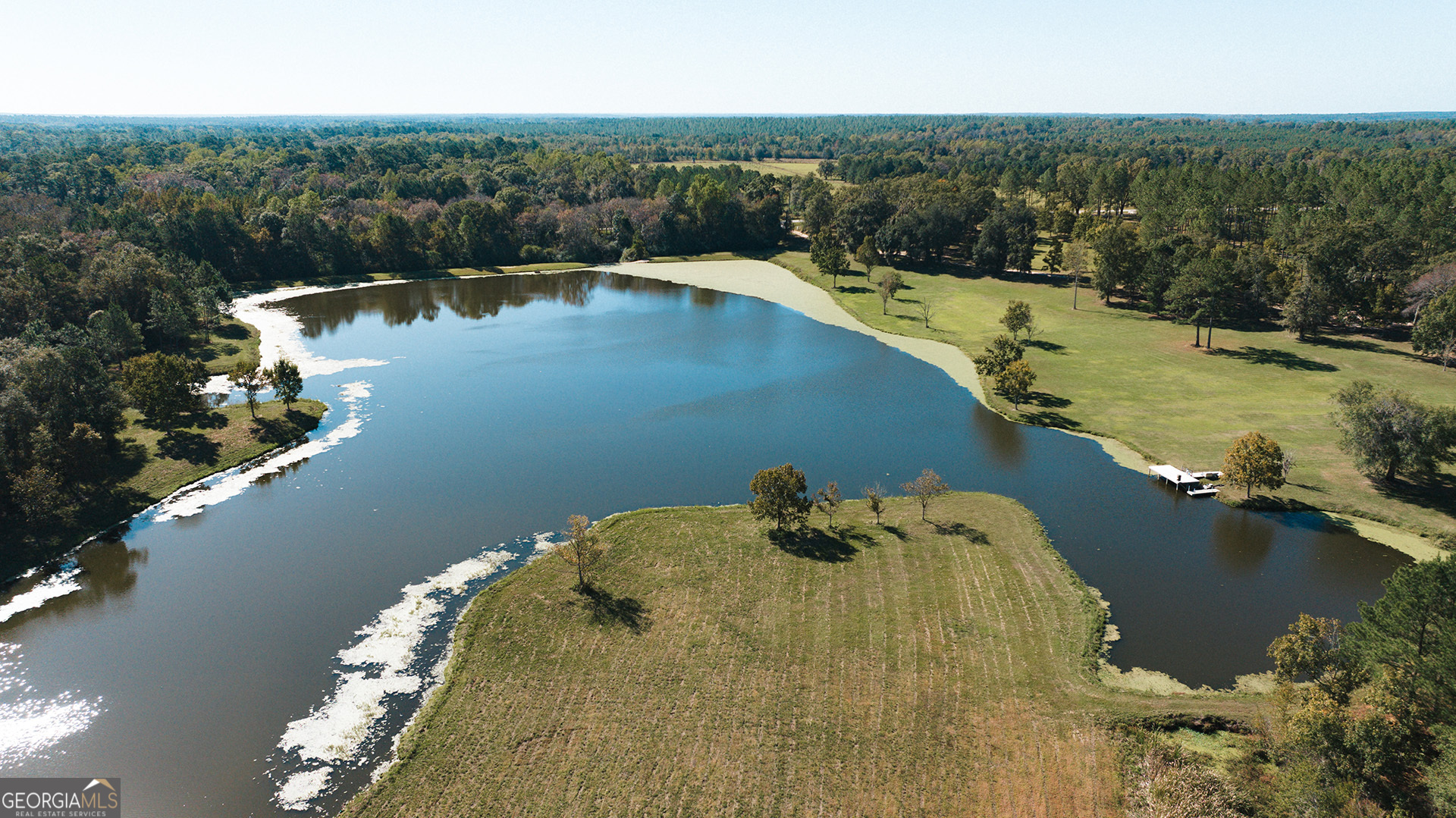 an aerial view of a house with a lake view