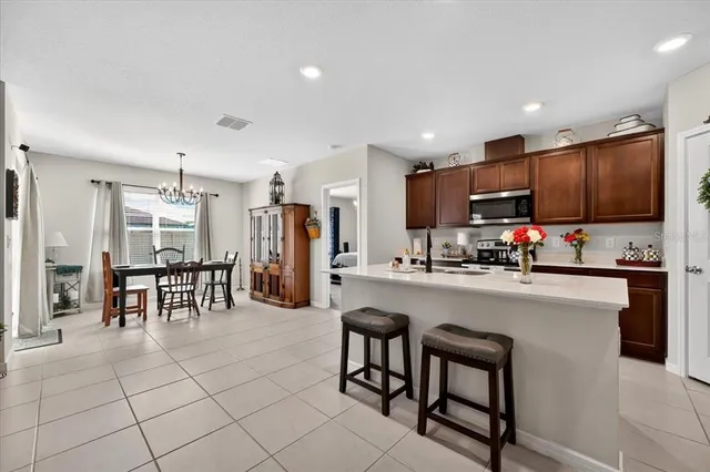 a kitchen with stainless steel appliances a refrigerator and a stove top oven