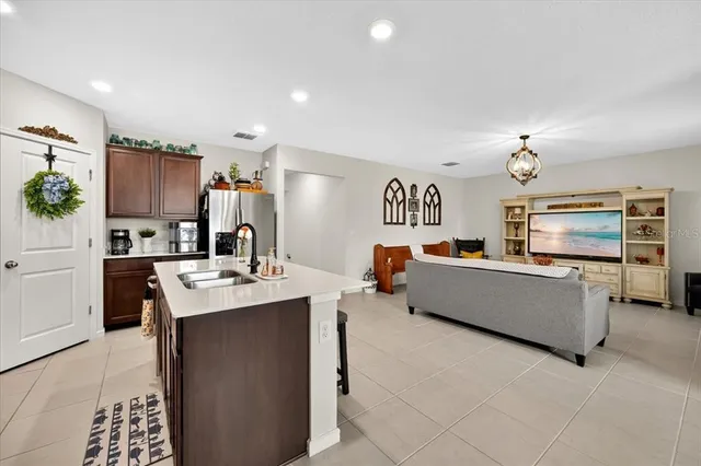 a living room with stainless steel appliances kitchen island granite countertop furniture and a kitchen view