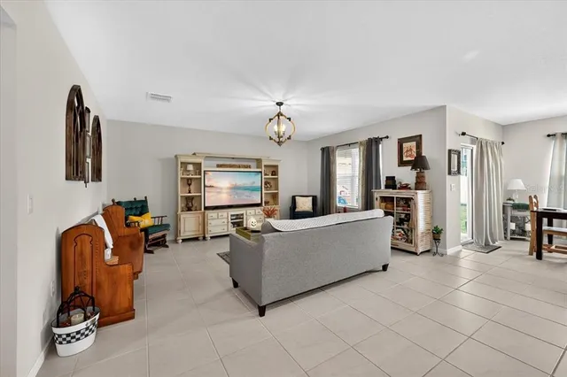 a living room with furniture a dining table and chairs with wooden floor