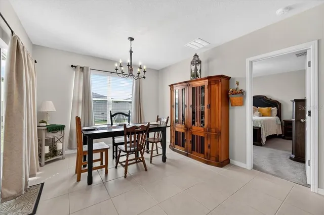 a view of a dining room with furniture and a chandelier