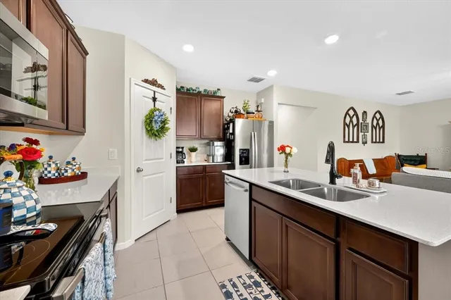 a kitchen with a sink appliances and cabinets