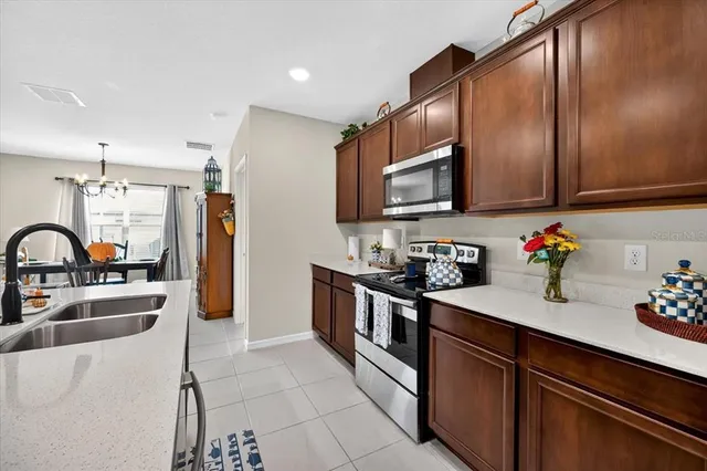 a kitchen with stainless steel appliances granite countertop a sink stove and cabinets
