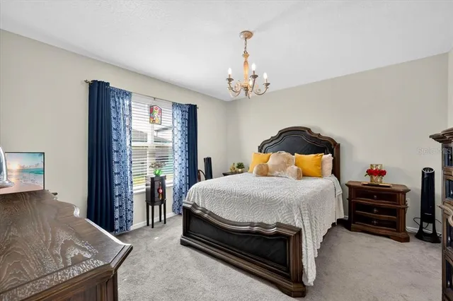 a bedroom with a bed and dresser with mirror