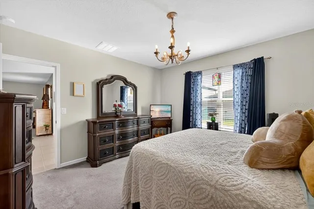 a bedroom with a large bed and a dresser