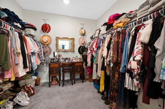 a view of walk in closet with clothes
