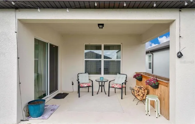 a balcony with furniture and a potted plant
