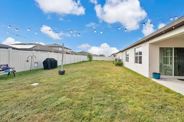 a swimming pool with yard and outdoor seating