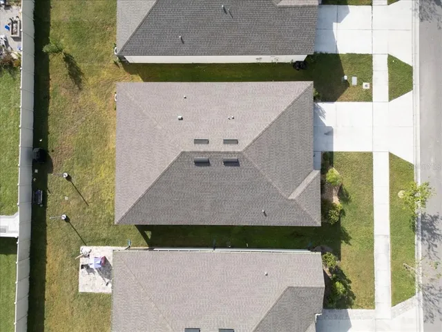 an aerial view of a house with a yard
