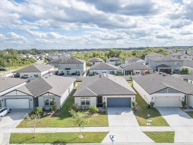 an aerial view of a houses with a big yard