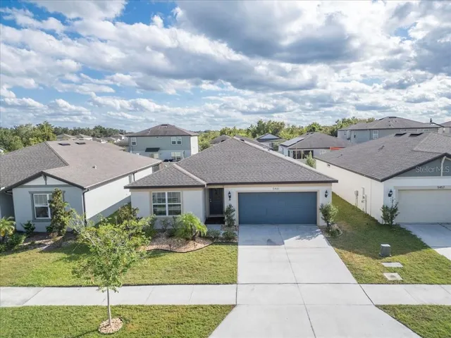 a house with green field in front of it