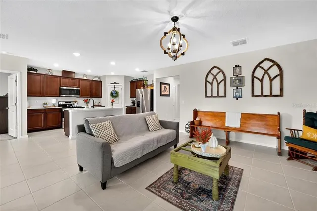 a living room with furniture kitchen view and a table