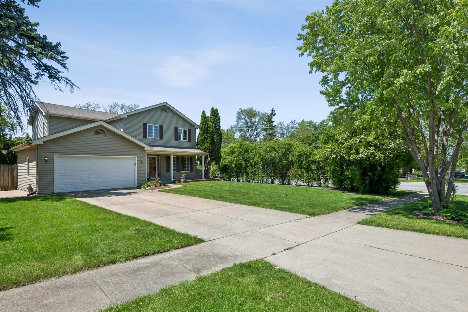 2142 North Summit Street Wheaton, IL 60187 - Photo 3 of 35 a front view of a house with a yard and garage