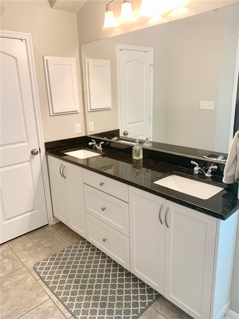 2019 Jester Trail Bryan, TX 77807 - Photo 18 of 25 a bathroom with a sink and a mirror