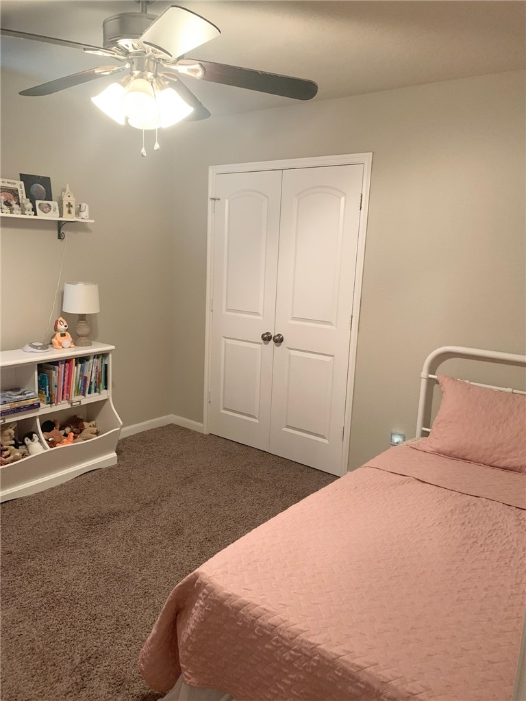 2019 Jester Trail Bryan, TX 77807 - Photo 21 of 25 a bedroom with a bed and a chandelier