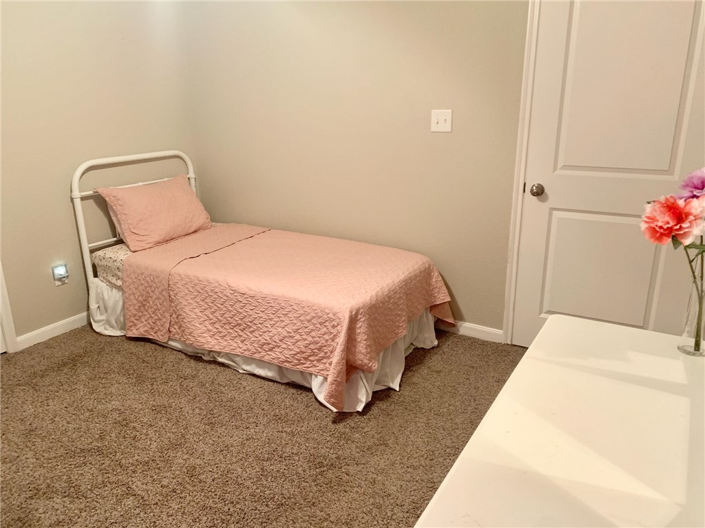 2019 Jester Trail Bryan, TX 77807 - Photo 22 of 25 a bedroom with a bed and a potted plant