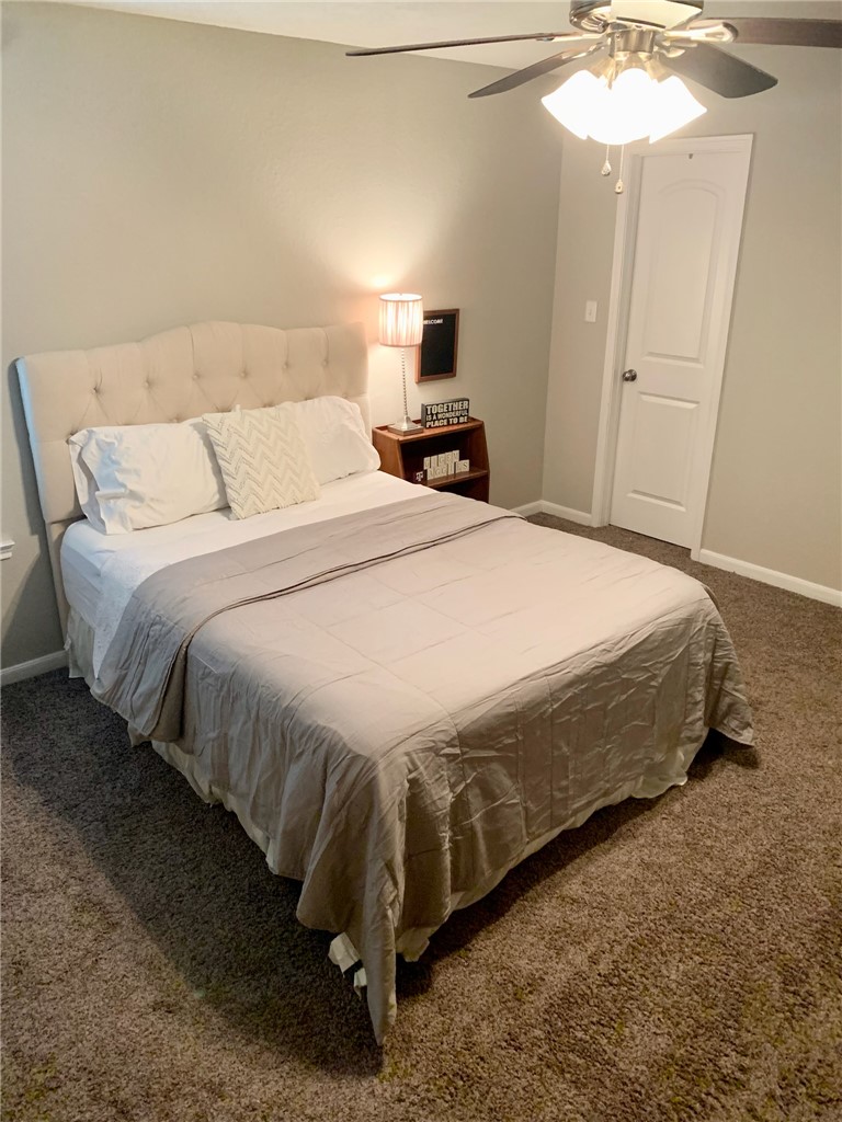 2019 Jester Trail Bryan, TX 77807 - Photo 24 of 25 a bedroom with a bed and a chandelier